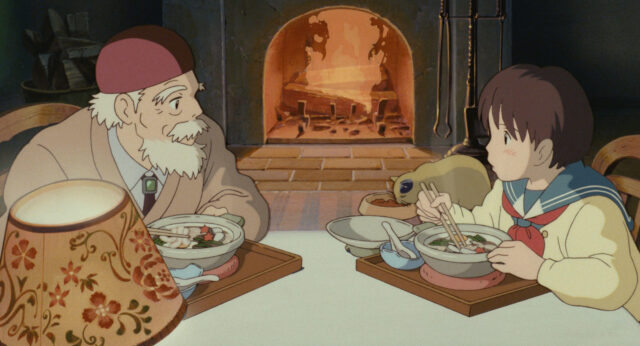 耳をすませばの雫とお爺さんが暖炉の前で鍋焼きうどんを食べている画像